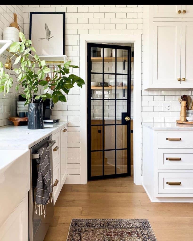 A_Kitchen_with_White_Cabinets_and_a_Blac_4