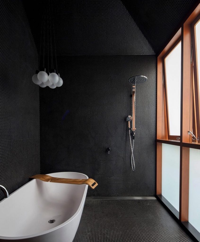 A_Modern_Bathroom_With_Black_Walls_and_S_