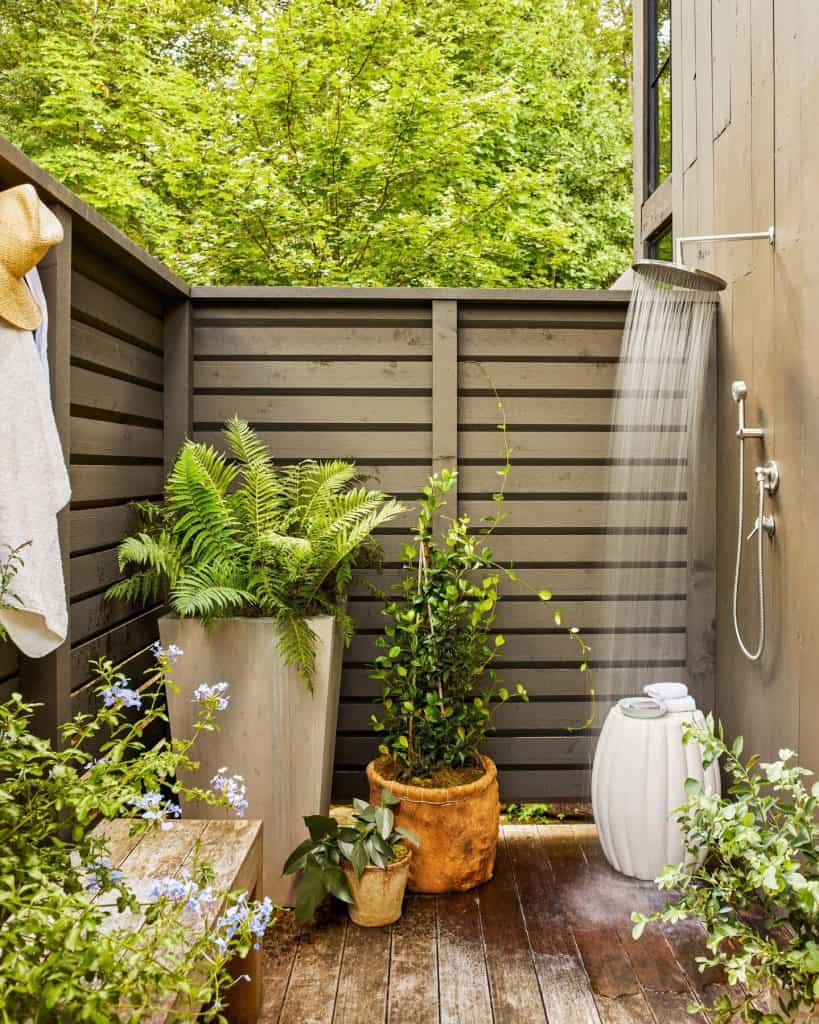 A_Wooden_Deck_with_a_Shower_and_Potted_P_3