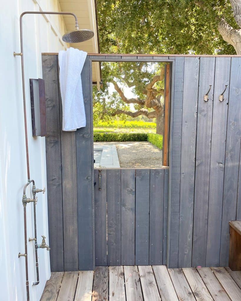 An_Outdoor_Wooden_Shower_with_a_Yellow_a_3