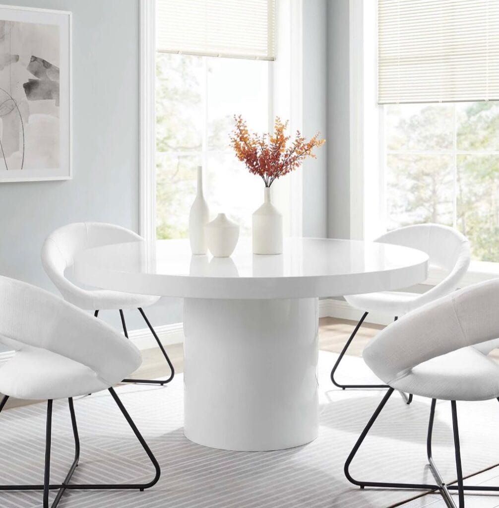 A_Table_With_Four_White_Chairs_and_a_Vas_2