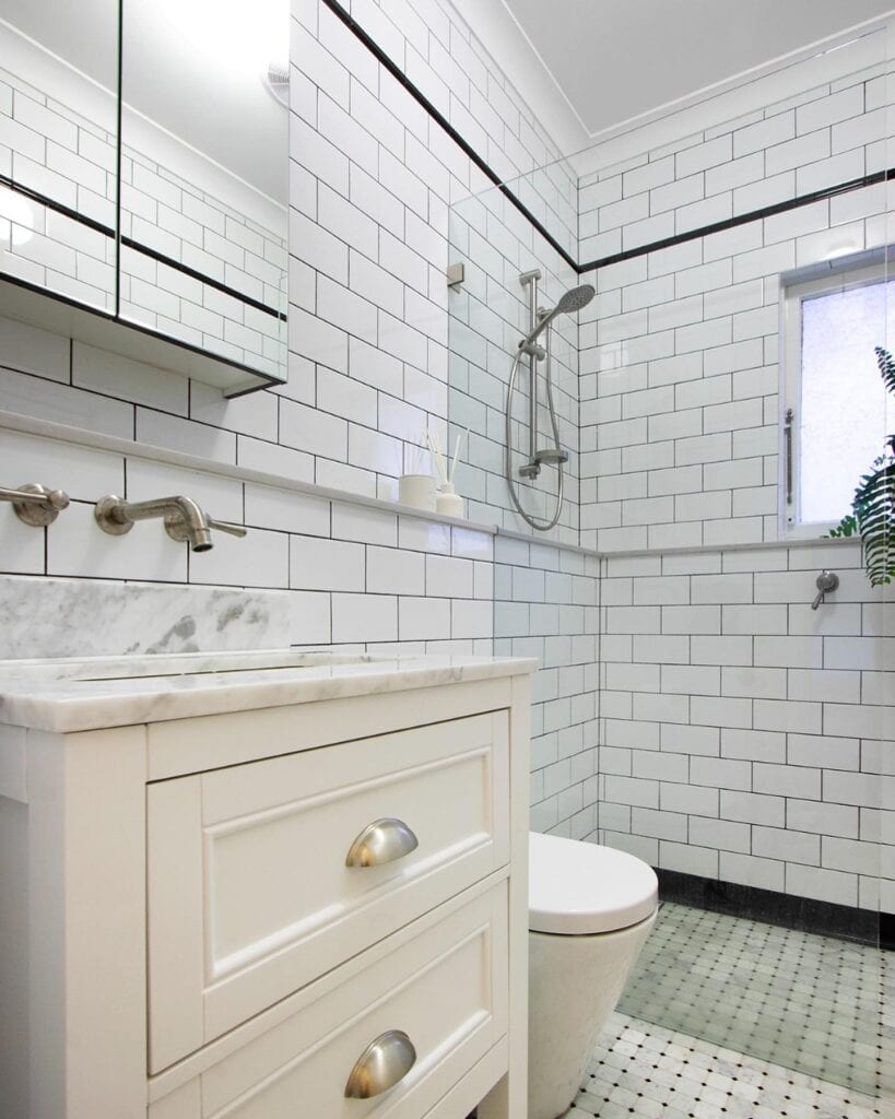 A_Bathroom_with_White_Subway_Tile_and_Gr_