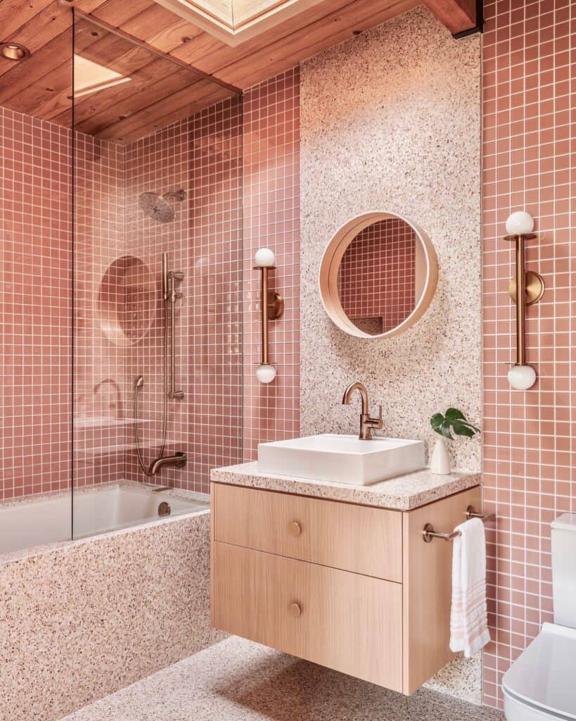 A_Bathroom_With_Pink_Tiled_Walls_and_a_W_1